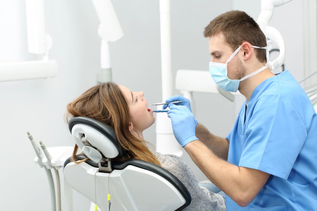 Dentist using a laser to treat a cavity, demonstrating how effective is laser dentistry for cavities. Learn more in Toms River, NJ. Call 732-838-9525.
